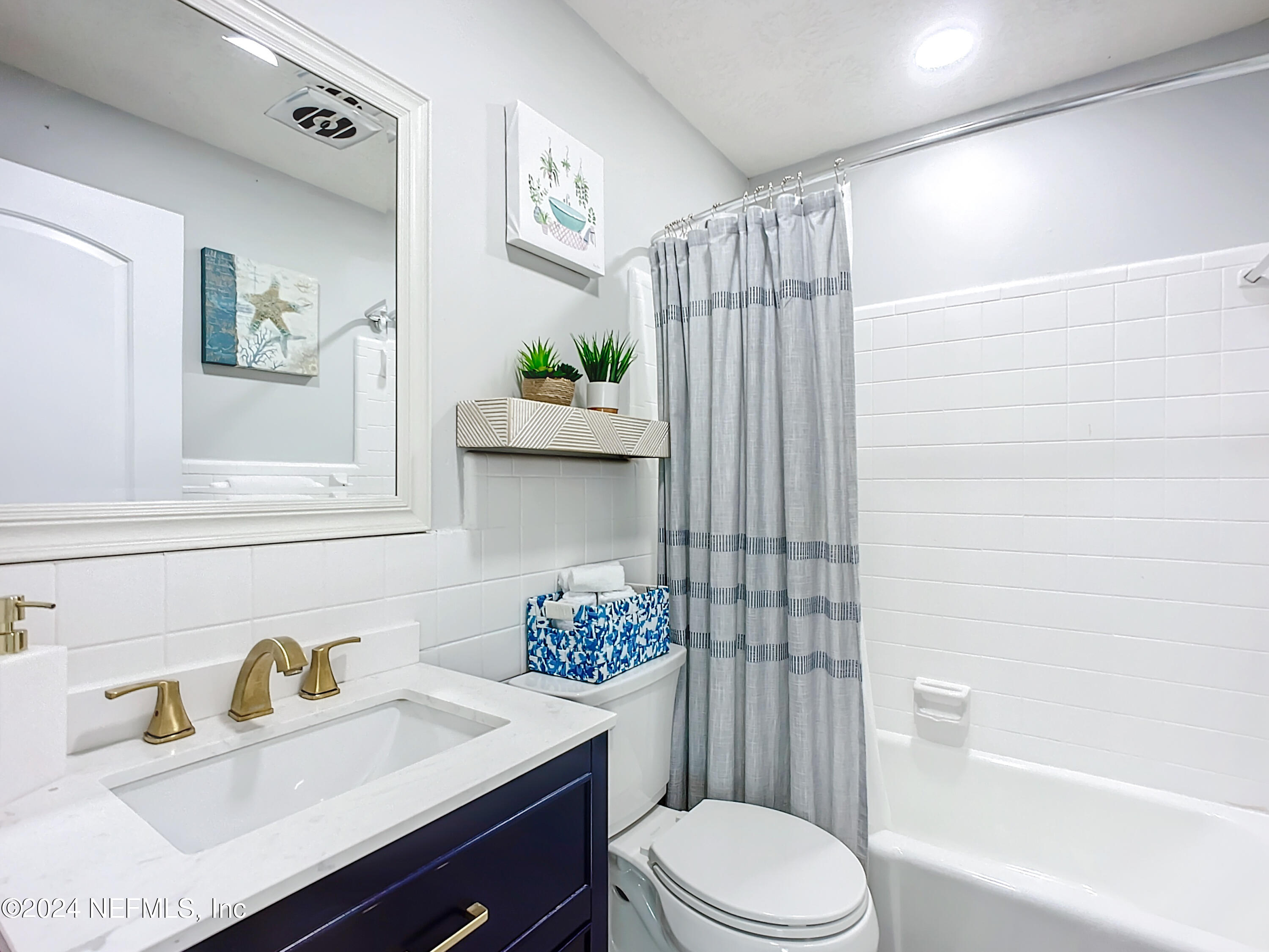 54 Surf Drive St. Augustine, FL 32080 - Photo 29 of 47 a bathroom with a sink a toilet and shower