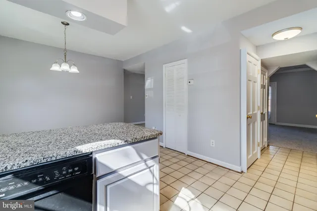 a open kitchen with granite countertop a sink and a stove