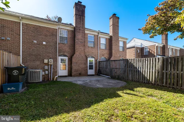 a front view of a house with a garden and plants