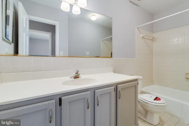 a bathroom with a sink toilet vanity and tub