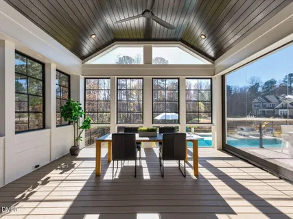 a view of a dining room with furniture large windows and wooden floor