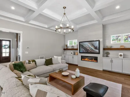 a living room with furniture and a chandelier