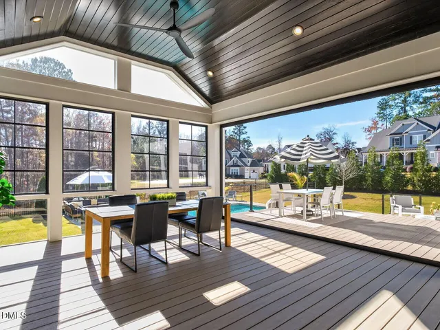 a large kitchen with kitchen island a stove a sink a oven and a chandelier