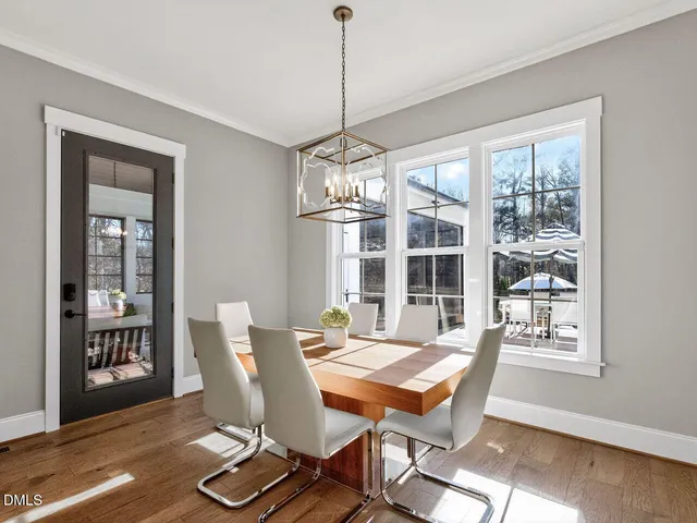 a living room with furniture chandelier and a window