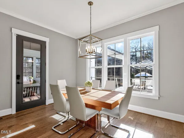 a living room with furniture chandelier and a window