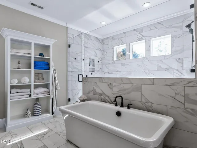 a bathroom with a toilet sink a mirror and window