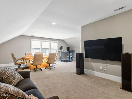 a bathroom with a toilet sink a mirror and window