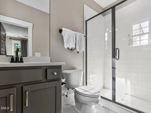 a bathroom with a sink a toilet and a mirror