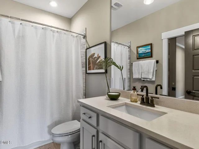 a view of a swimming pool with a bench and lawn chairs under an umbrella