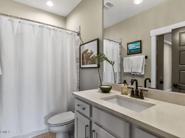 a view of a swimming pool with a bench and lawn chairs under an umbrella