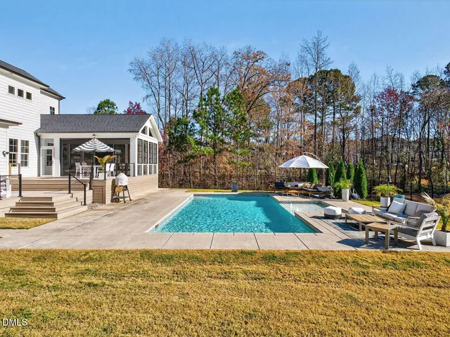 a swimming pool with outdoor seating and yard