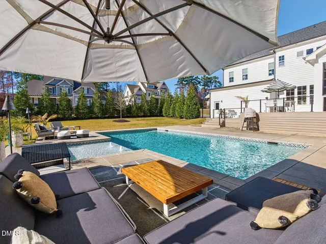 a view of house with outdoor space and swimming pool