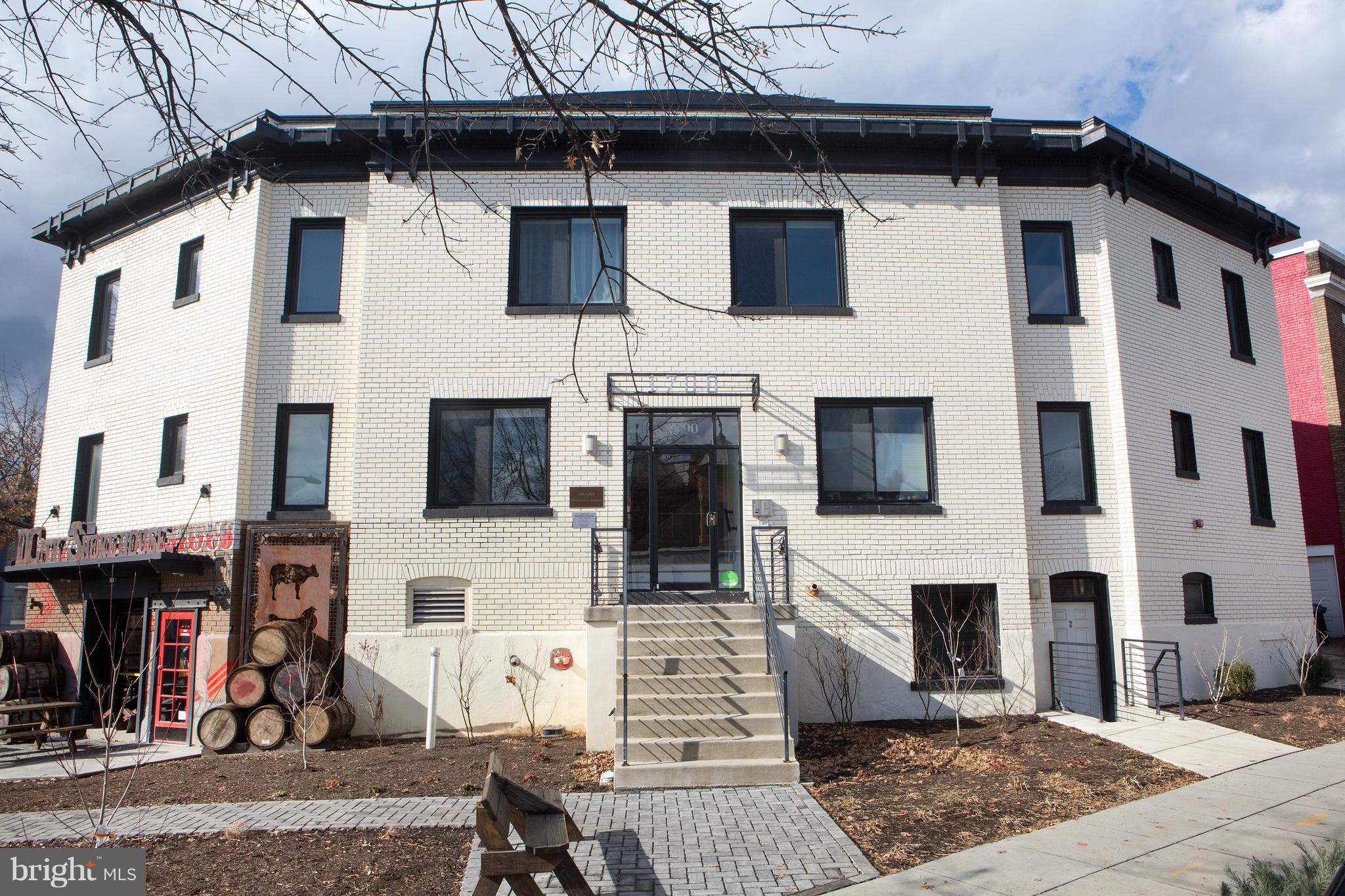 1700 2nd Street Northwest, Unit 9 Washington, DC 20001 - Photo 2 of 26 a view of a white building with many windows