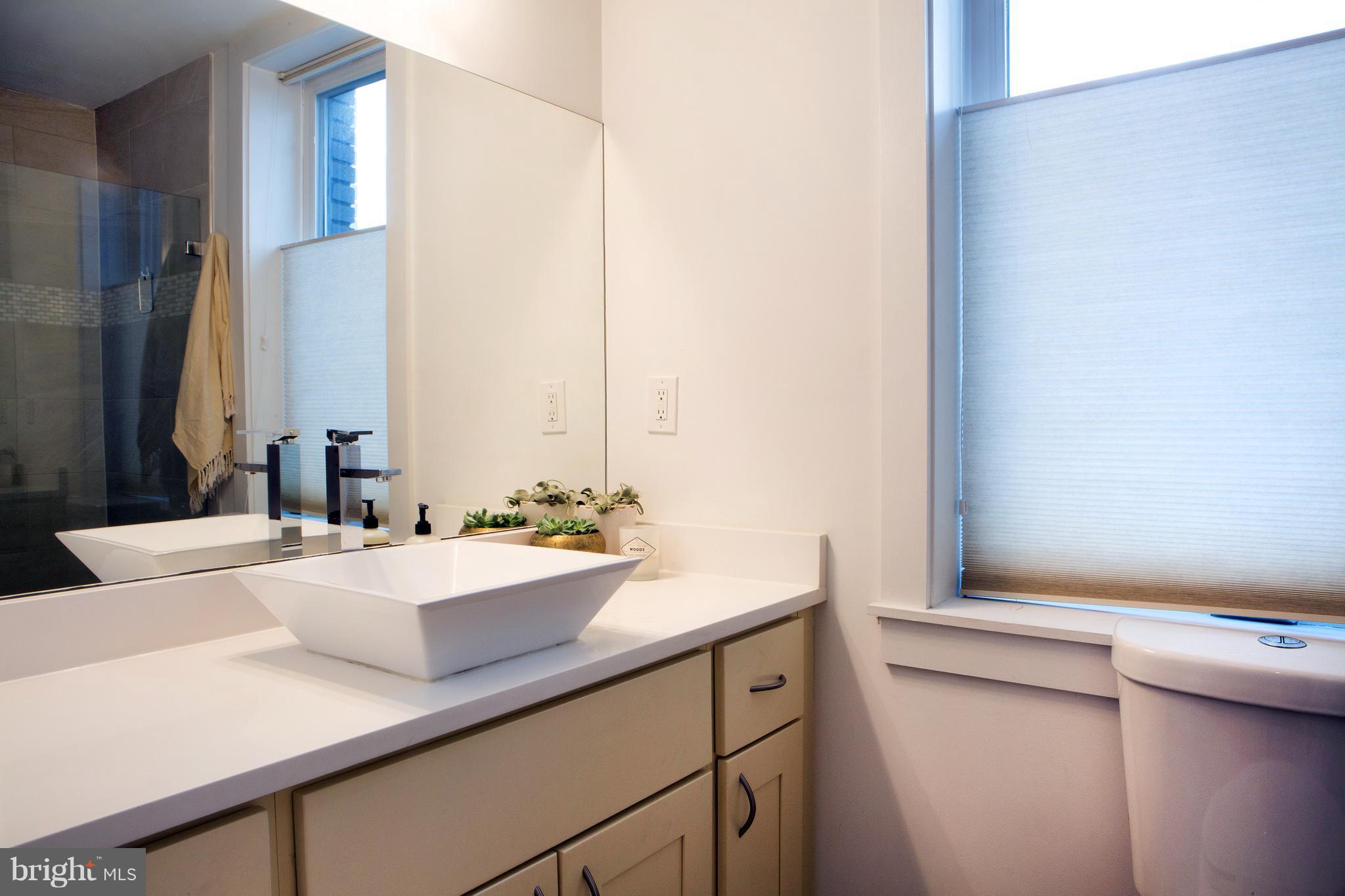 1700 2nd Street Northwest, Unit 9 Washington, DC 20001 - Photo 14 of 26 a bathroom with a sink and a mirror