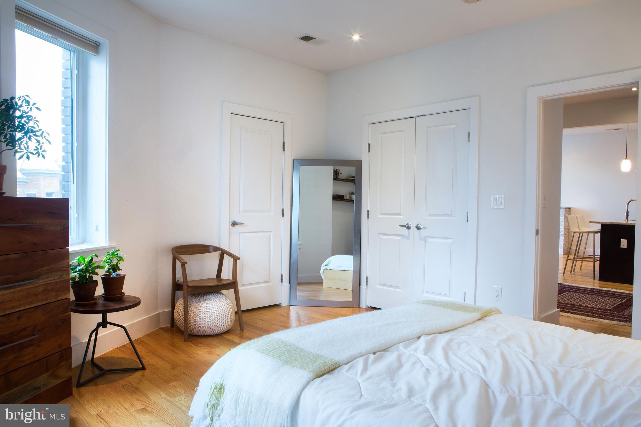 1700 2nd Street Northwest, Unit 9 Washington, DC 20001 - Photo 20 of 26 a bedroom with bed and a potted plant
