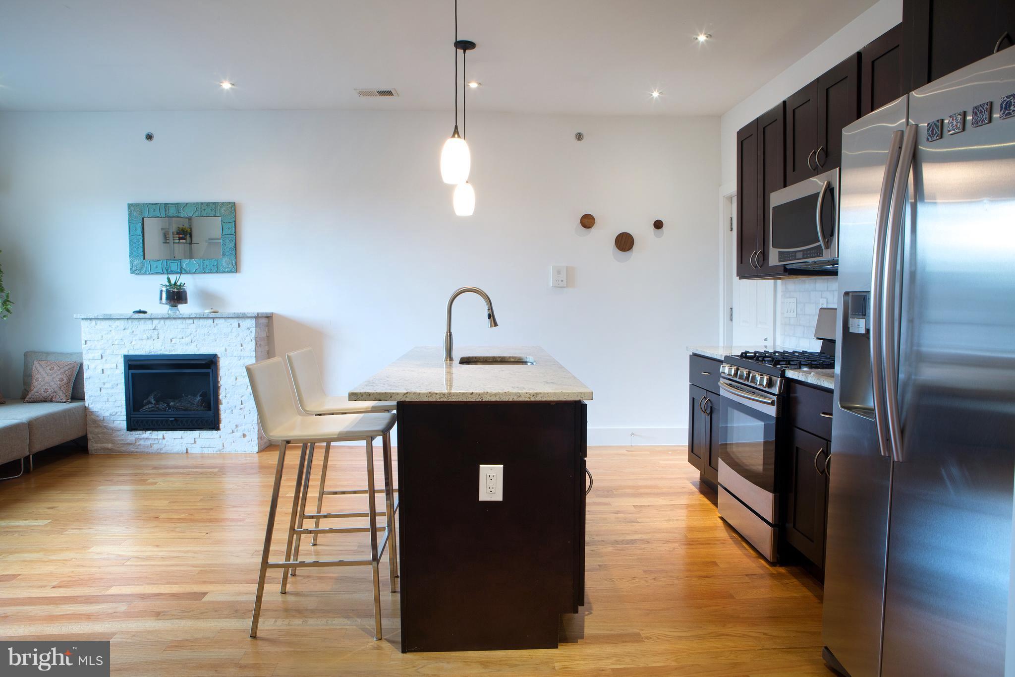 1700 2nd Street Northwest, Unit 9 Washington, DC 20001 - Photo 4 of 26 a kitchen with stainless steel appliances granite countertop a refrigerator a stove and a sink
