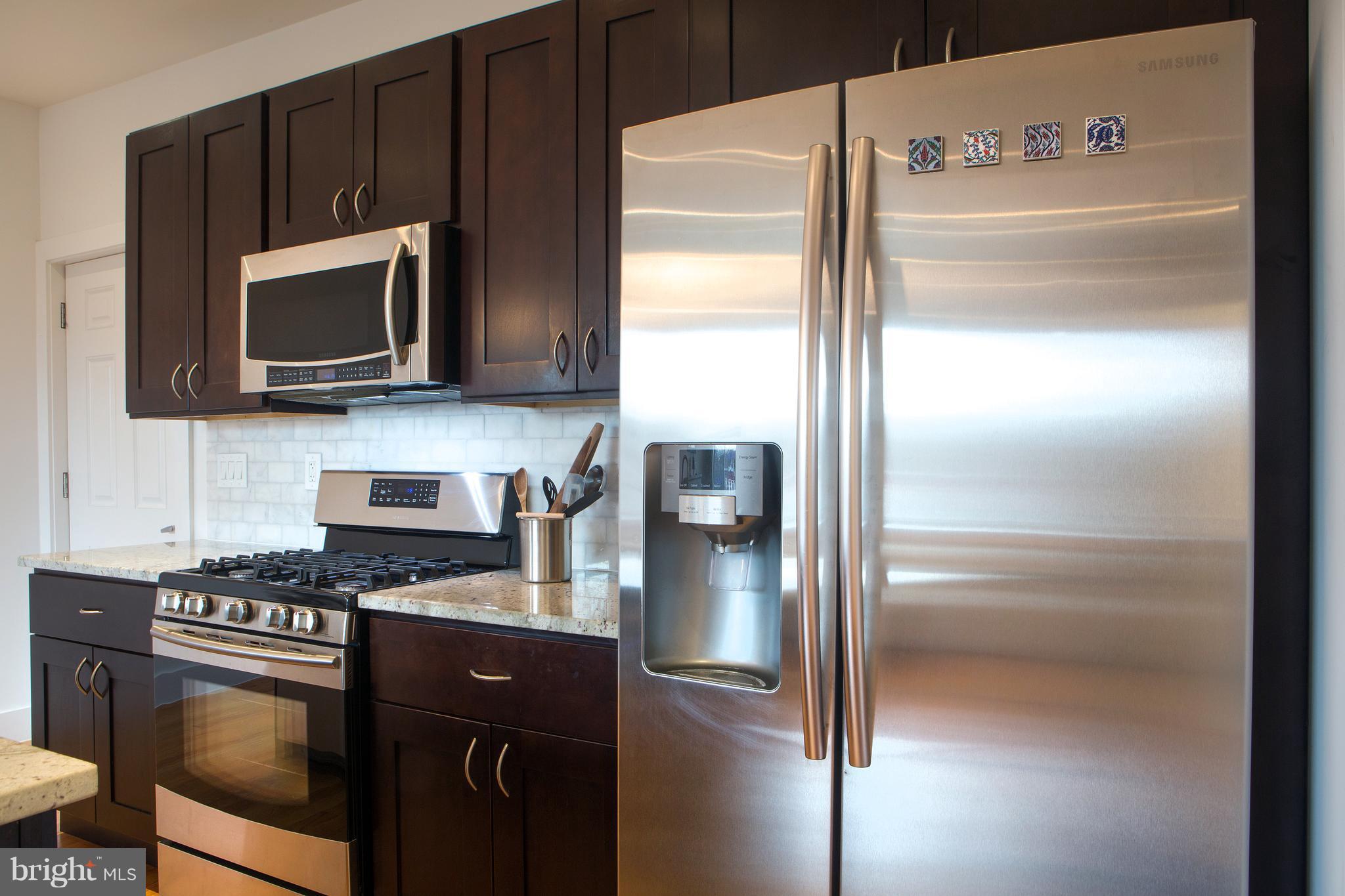 1700 2nd Street Northwest, Unit 9 Washington, DC 20001 - Photo 7 of 26 a kitchen with a refrigerator stove and microwave