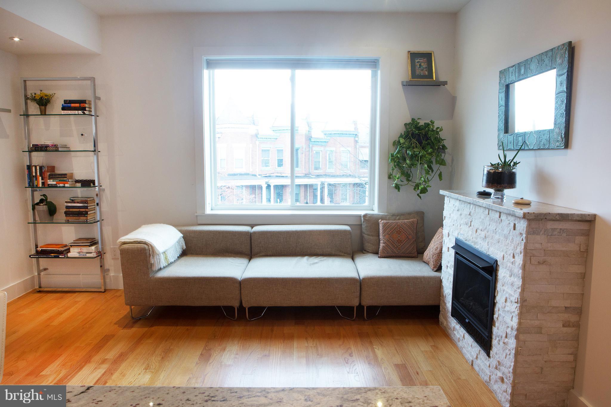 1700 2nd Street Northwest, Unit 9 Washington, DC 20001 - Photo 9 of 26 a living room with furniture and a fireplace
