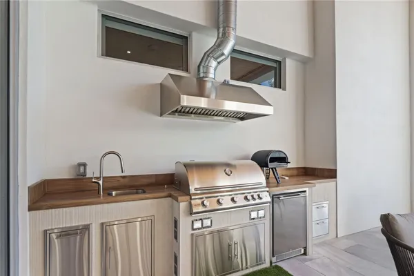a view of a patio with table and chairs and wooden fence