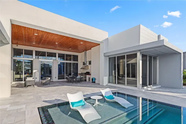 a bedroom with furniture and a large window