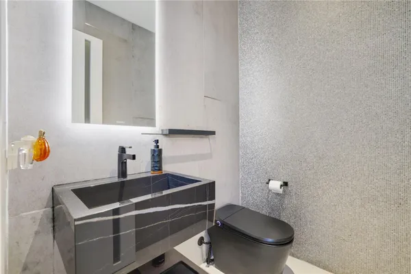 a kitchen with stainless steel appliances granite countertop a sink and a stove next to a window