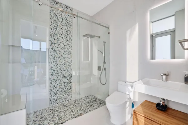 a bathroom with a sink toilet and shower