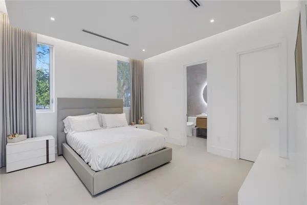 a bedroom with a large bed and a couch