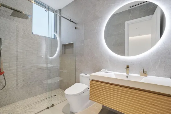 a bathroom with a sink toilet and shower