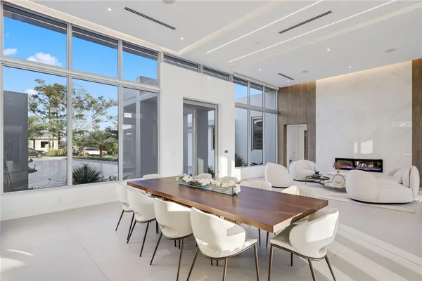 a kitchen with a table chairs refrigerator and cabinets