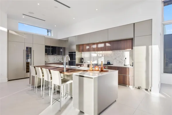 a large kitchen with stainless steel appliances granite countertop a lot of counter space and a sink