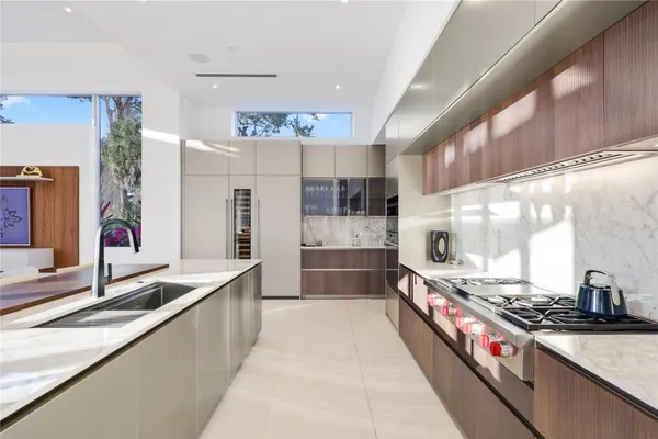 a kitchen with stainless steel appliances a stove and a sink