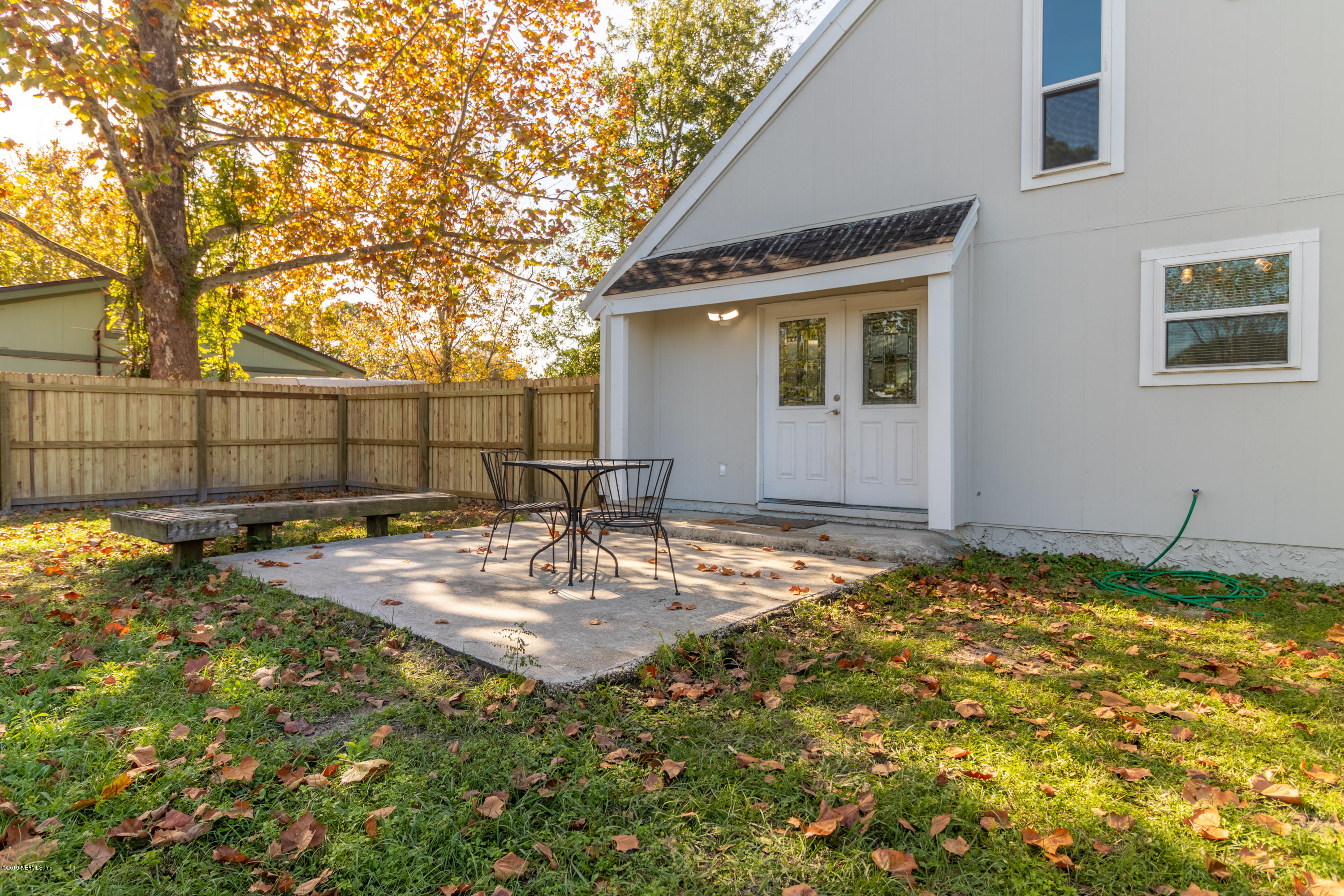 2465 Summer Tree Road East Jacksonville, FL 32246 - Photo 27 of 32 a backyard of a house with table and chairs
