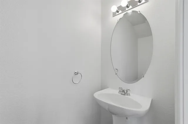 a bathroom with a sink and mirror