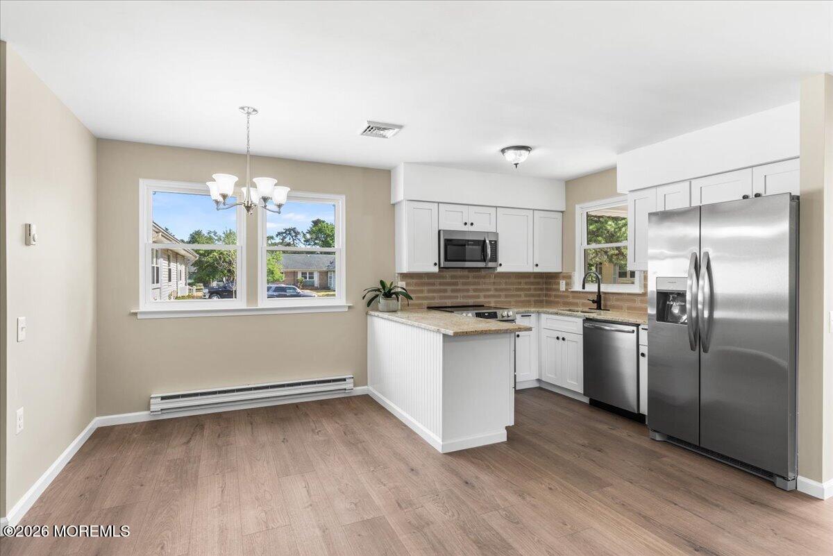16 D Spring Street, Unit 50 Whiting, NJ 08759 - Photo 14 of 28 a kitchen with a refrigerator and a stove top oven