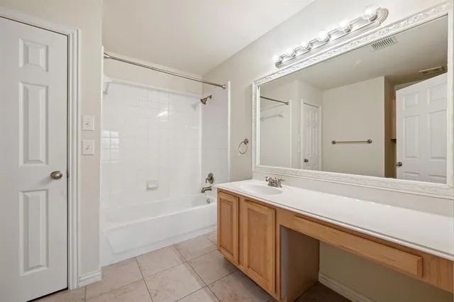 a spacious bathroom with a sink a mirror and a bathtub