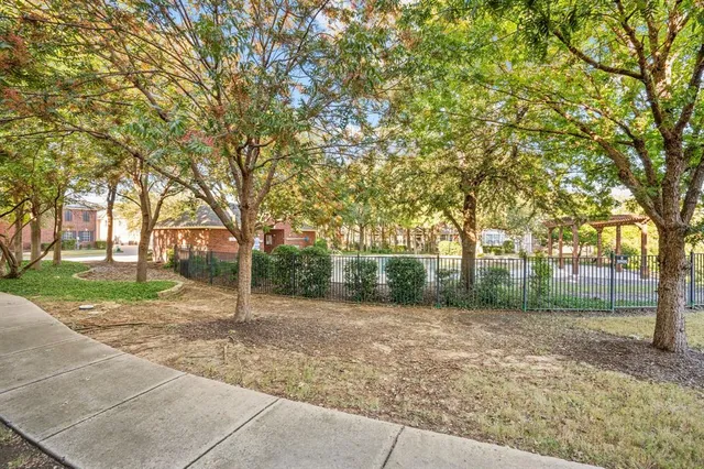 a view of a swimming pool with a patio and a yard