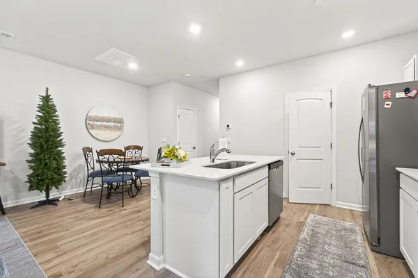 a kitchen with a refrigerator and a table in it