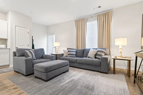 a living room with furniture and a large window