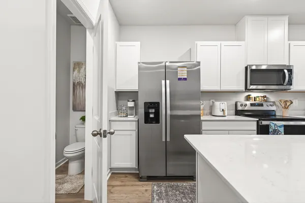 a kitchen with stainless steel appliances a refrigerator and a stove
