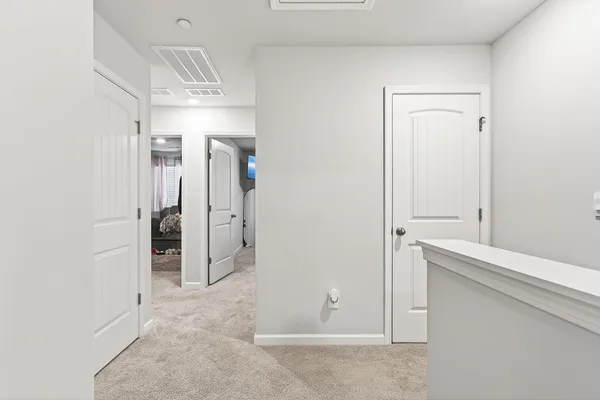 a spacious bedroom with a bed and a rug