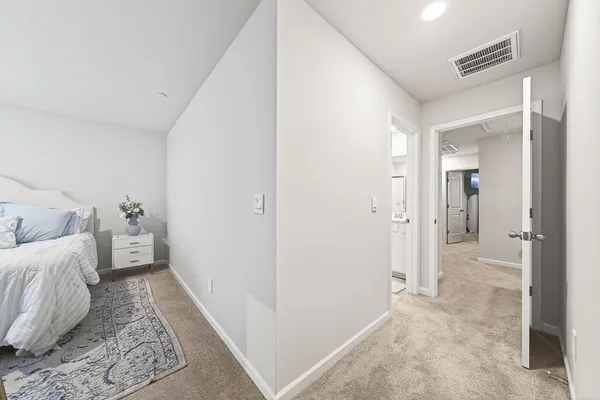 a large room with a bed and large windows