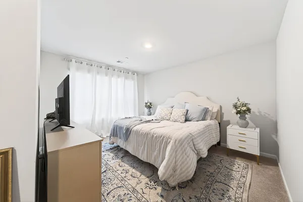 a bedroom with a bed and a dresser