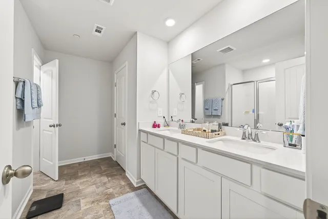 a bathroom with a glass shower door and a glass door
