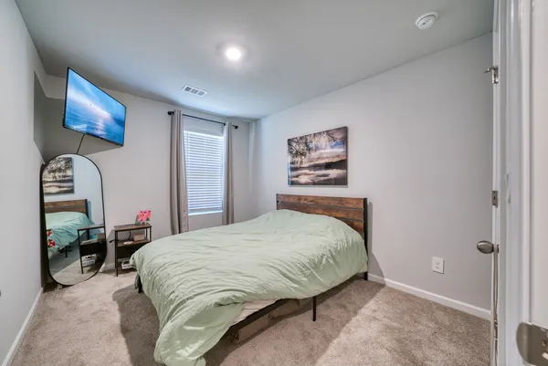 a bedroom with bed and window