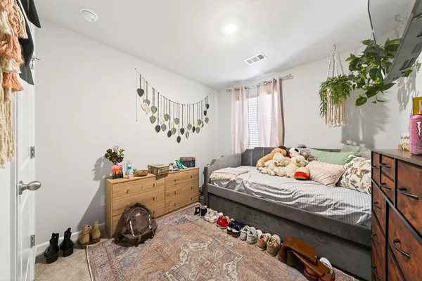a bathroom with a sink a toilet and shower curtain