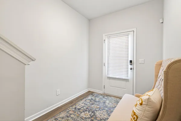 a view of a bedroom with a bed and a window