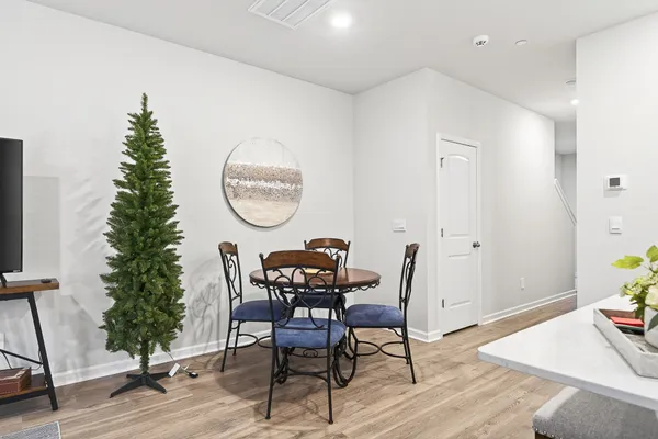 a view of a dining room with furniture and wooden floor