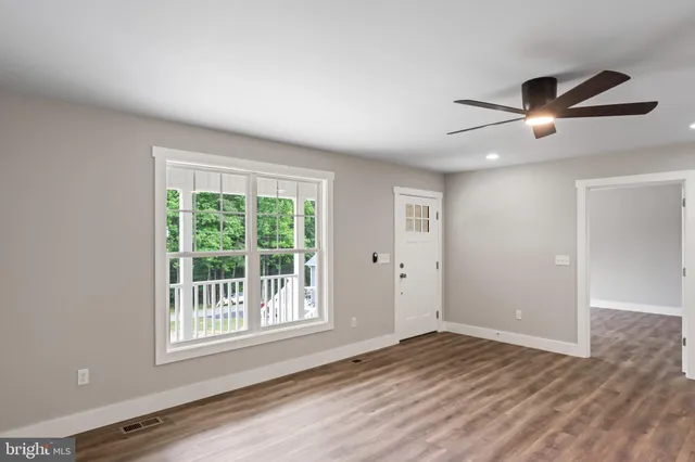 a kitchen with stainless steel appliances granite countertop a stove a refrigerator a sink and a oven with wooden floor