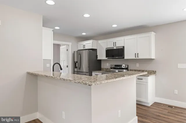 a view of a kitchen from the hallway