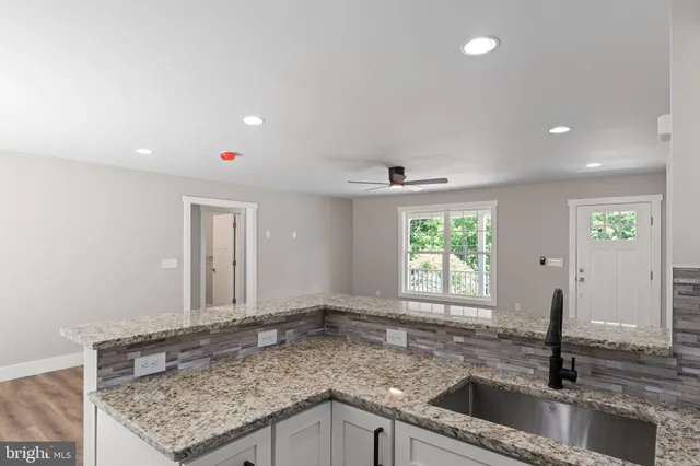 a view of an empty room and wooden floor